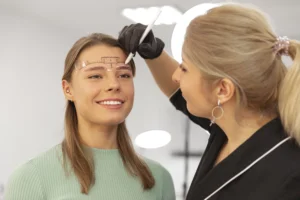 beautiful young woman going through microblading treatment