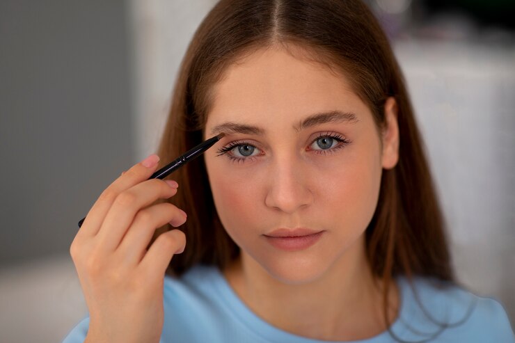 Front view girl doing her eyebrows